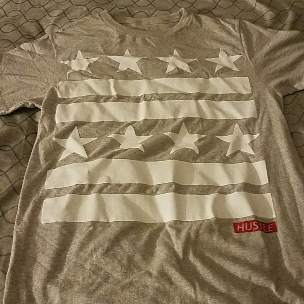 I am selling a grey/white Hustle T-Shirt KidsSizeM